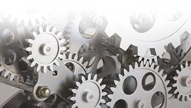 Interlocking silver metal gears arranged in a complex mechanical assembly, representing smooth motion and efficiency.