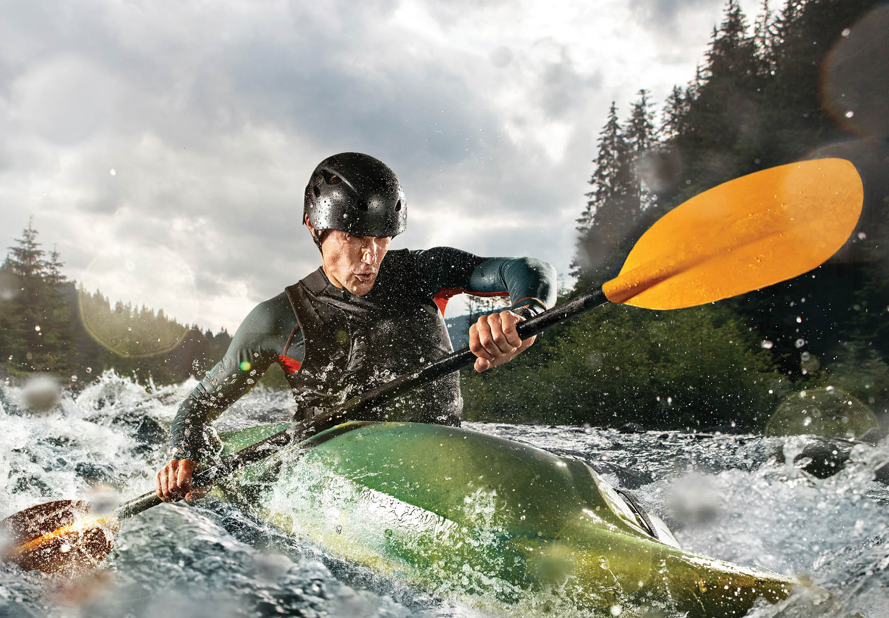 Whitewater kayaking, extreme kayaking. A guy in a kayak sails on a mountain river